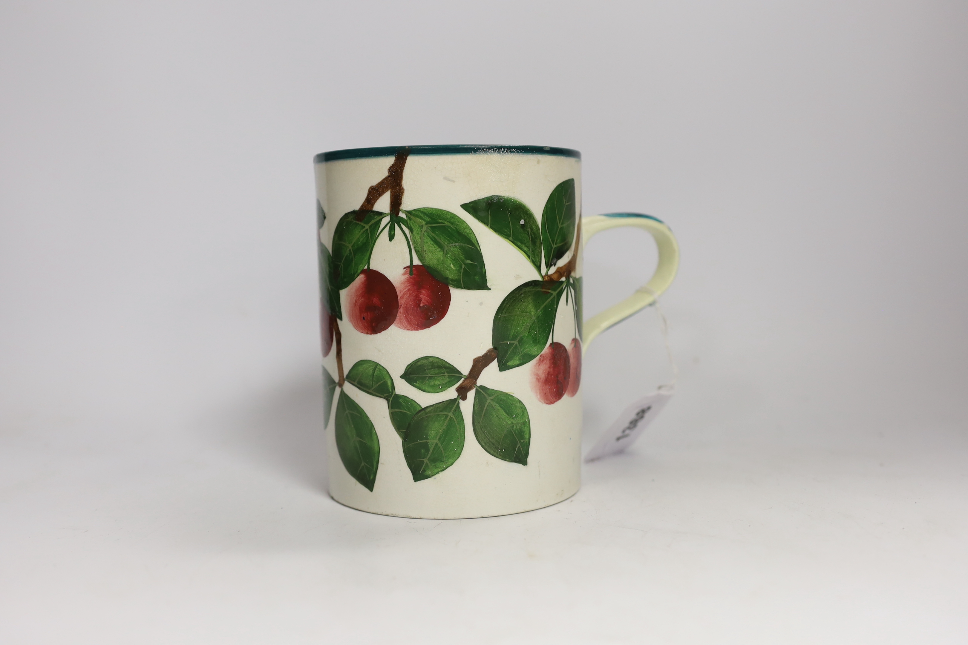 A Wemyss mug with cherry decoration (restored a.f.), 14cm high